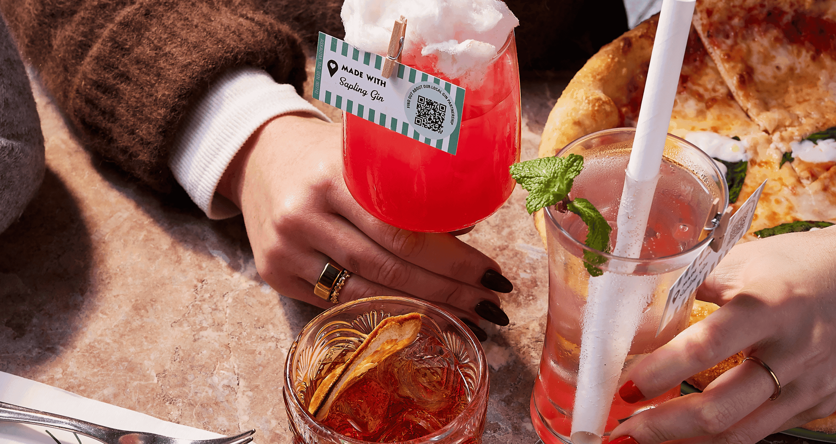 A photograph of three cocktails on a table
